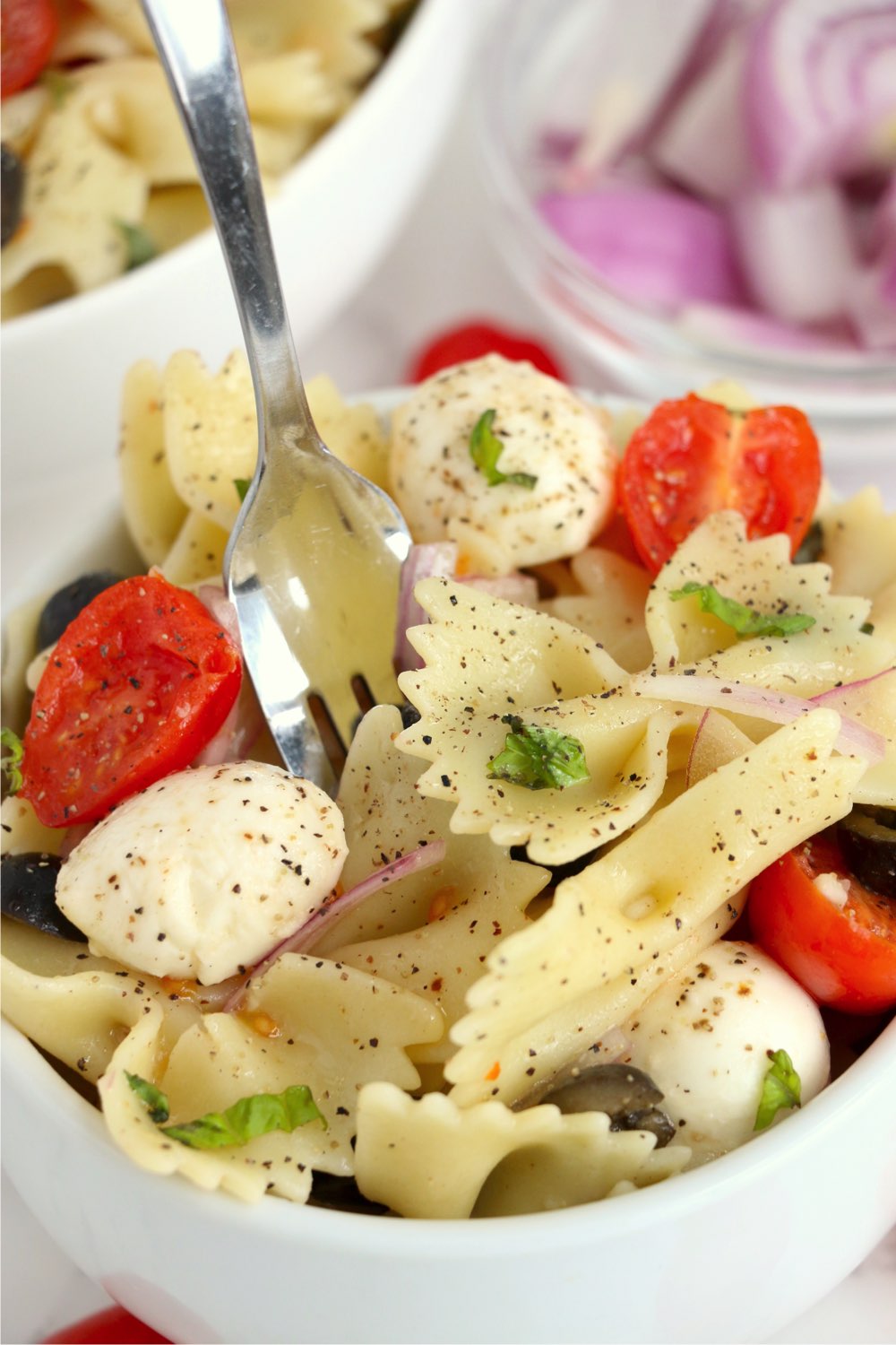 fork digging into bowl of pasta salad
