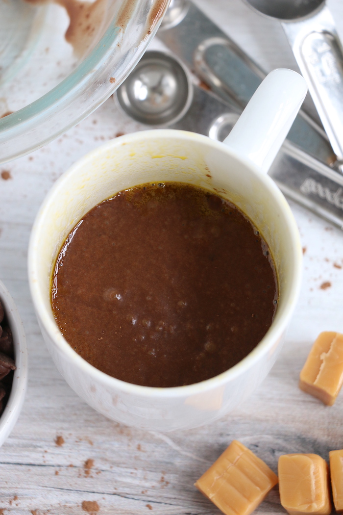 mug filled half full with chocolate cake batter