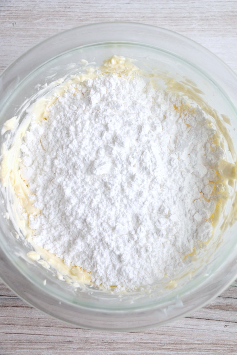 powdered sugar on top of cream cheese and butter mixture