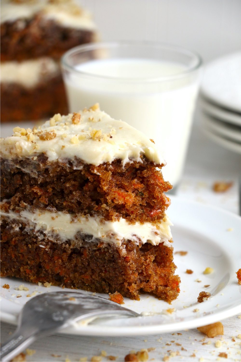 Piece of carrot cake being eaten with fork
