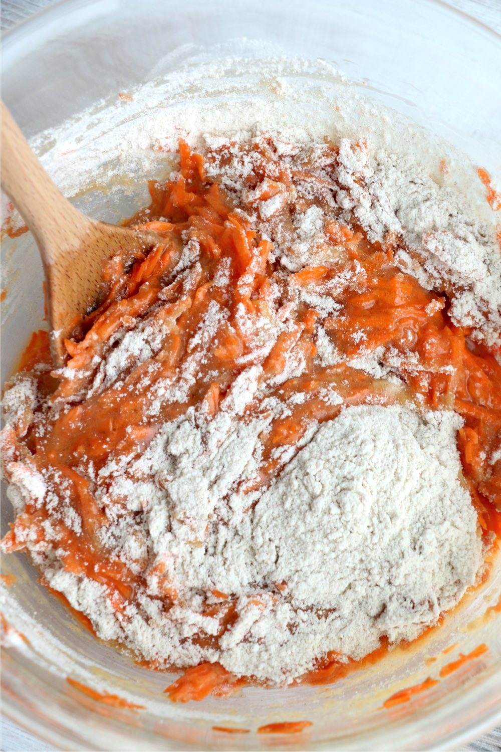 Incorporating dry ingredients to wet ingredients for carrot cake