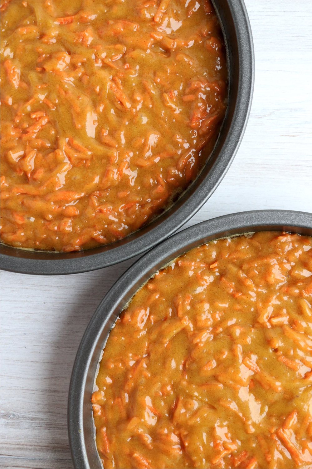 two baking pans filled with carrot cake batter