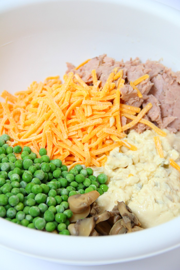 Classic Tuna Noodle Casserole - Ready in under 45 minutes, this classic and comforting casserole features tuna, onions, mushrooms, peas and cheese in a creamy sauce topped with more cheese and crunchy French fried onions! So flavorful, and sure to satisfy the entire family!