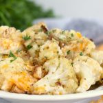 plate of cauliflower topped with cheese and parsley