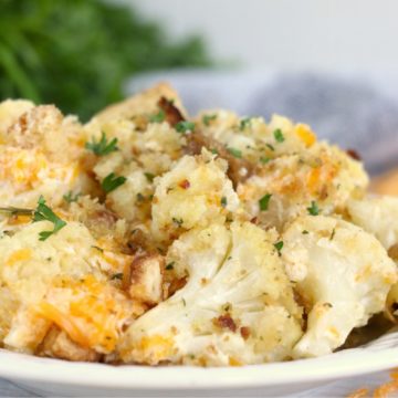 plate of cauliflower topped with cheese and parsley
