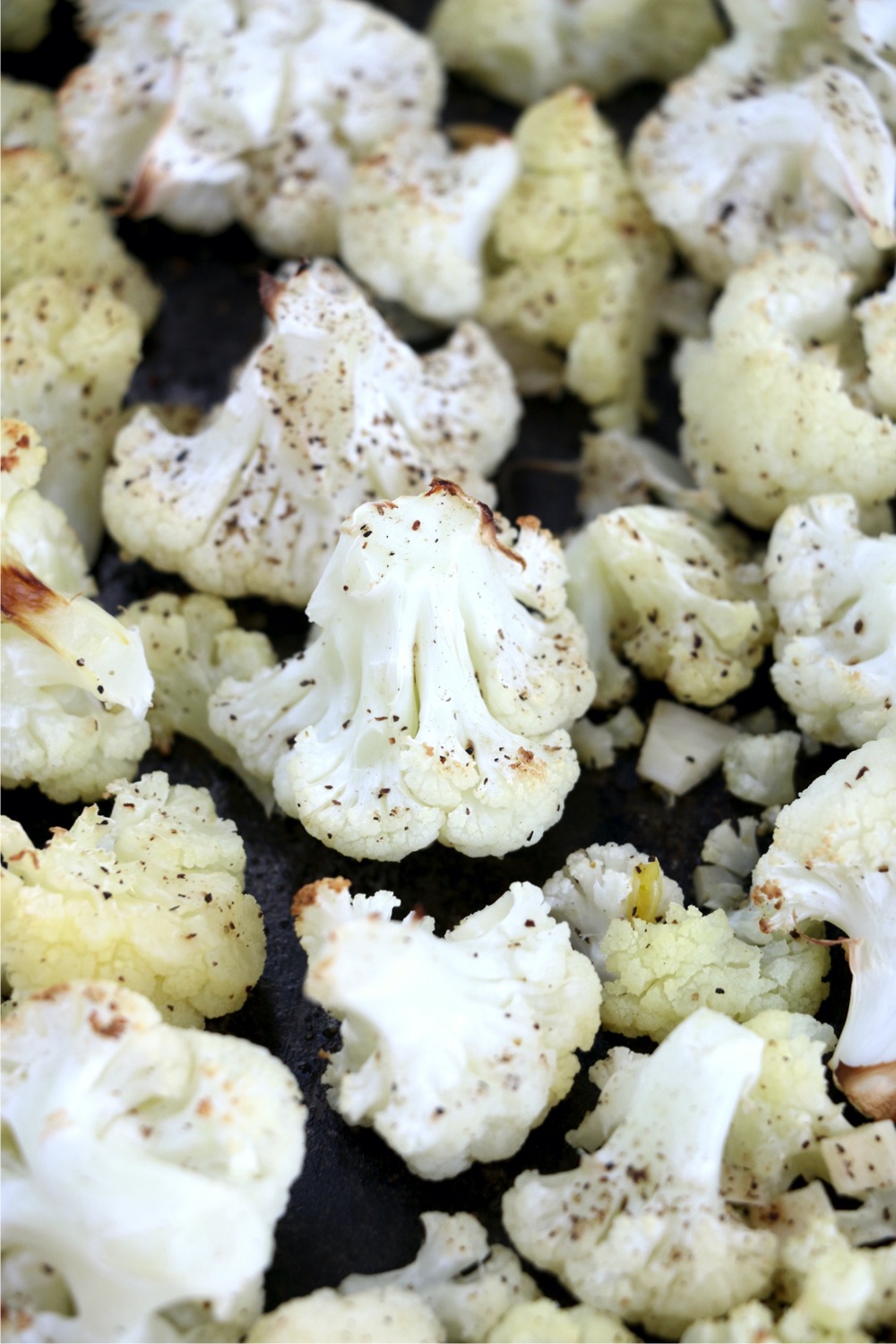 Seasoned, roasted cauliflower on cookie sheet