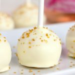 row of cake pops on a white platter