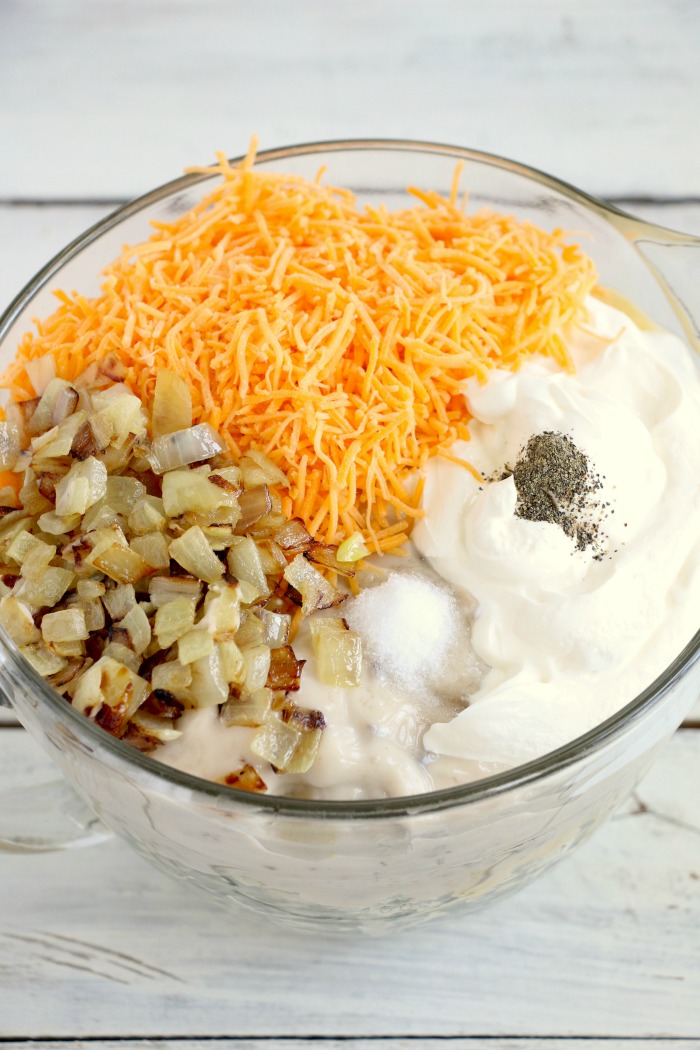 Cheesy Hashbrown Potatoes - Cheesy potato casserole topped with crunchy French fried onions! One of the best hash brown casserole recipes out there!