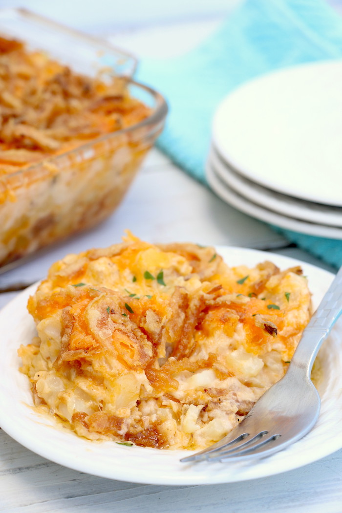 Cheesy Hashbrown Potatoes - Cheesy potato casserole topped with crunchy French fried onions! One of the best hash brown casserole recipes out there!