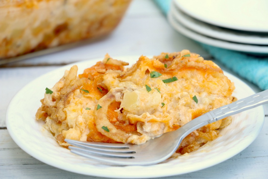 Cheesy Hashbrown Potatoes - Cheesy potato casserole topped with crunchy French fried onions! One of the best hash brown casserole recipes out there!