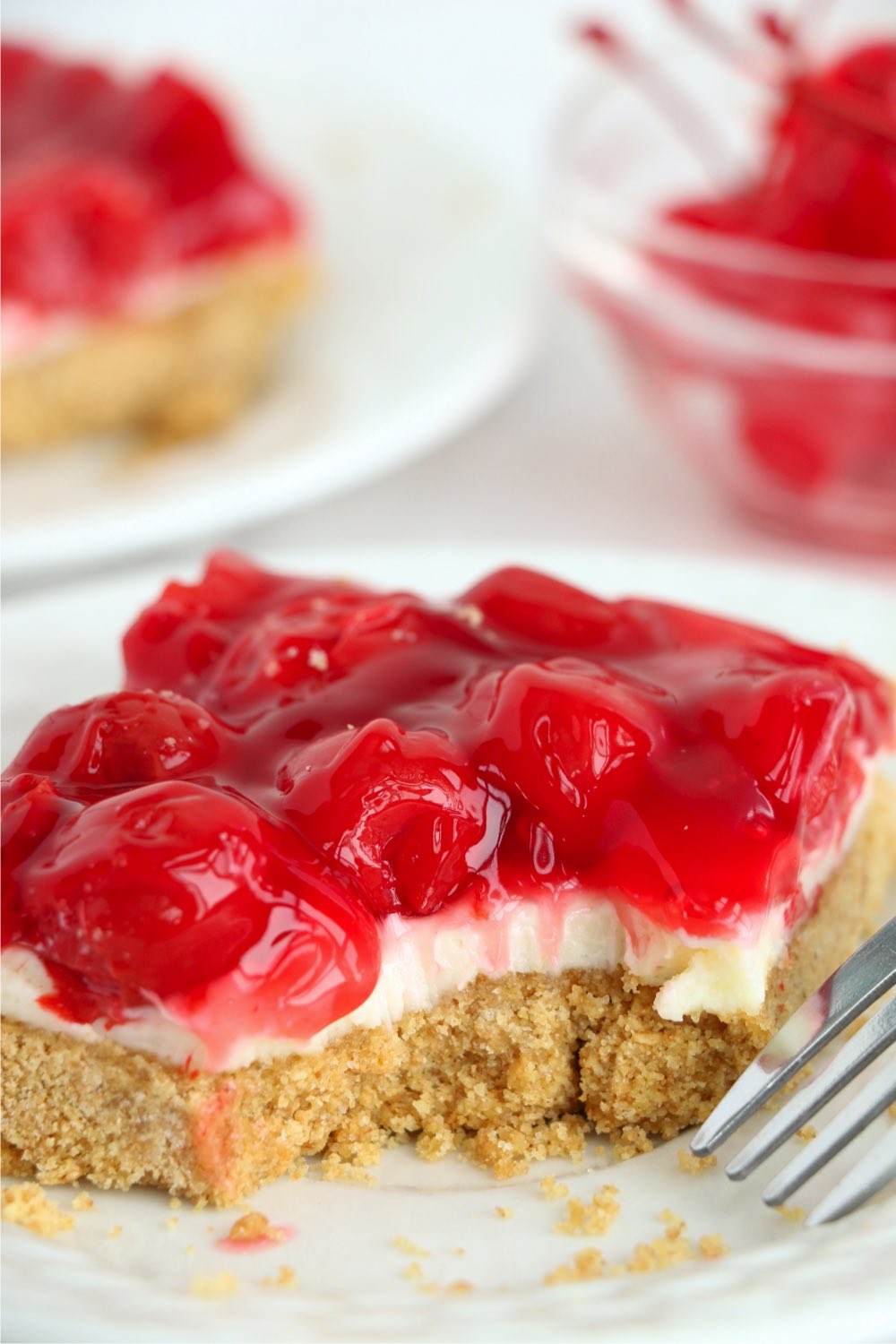 bite out of piece of cherry cheesecake bar