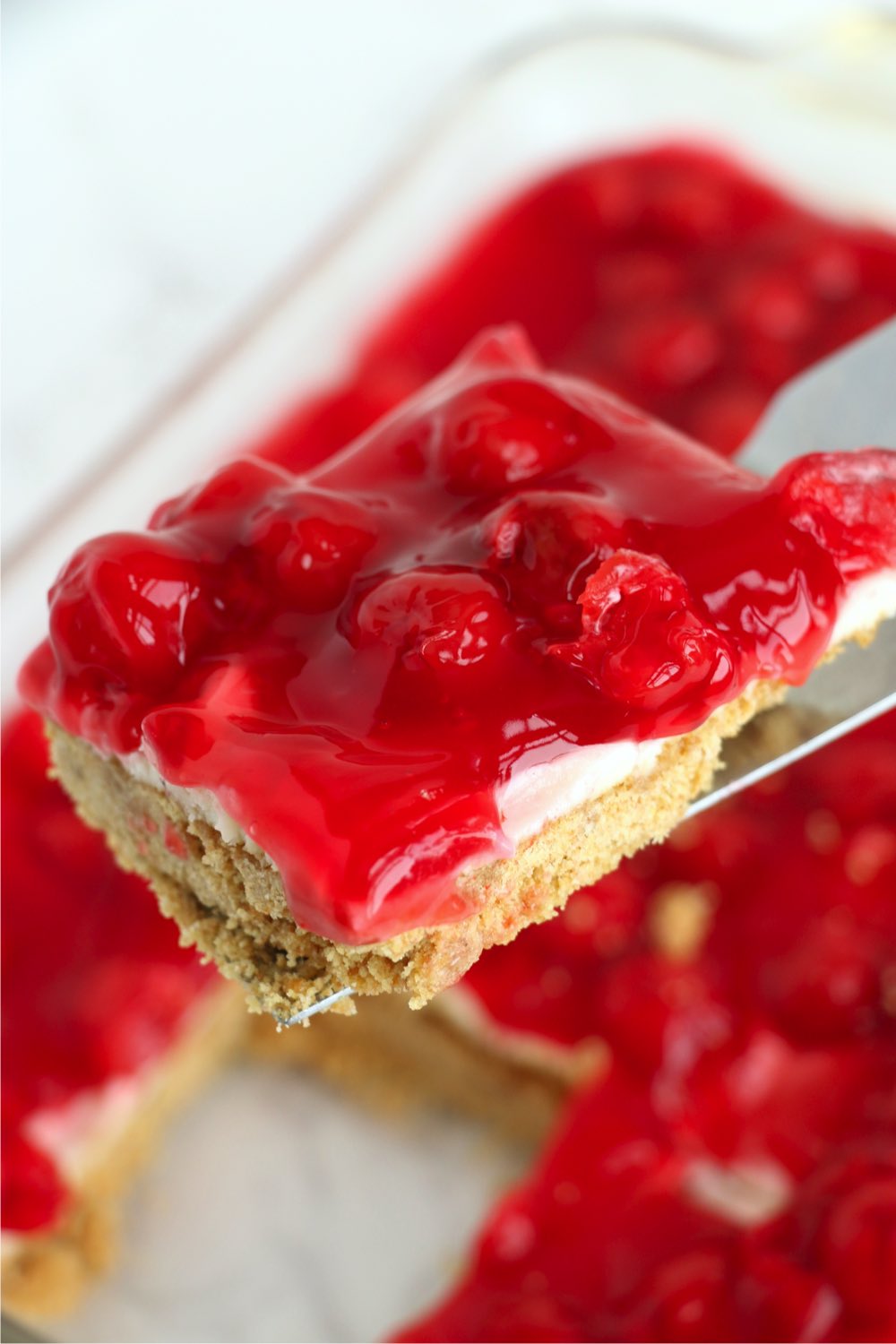 spatula holding cherry dessert bar