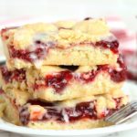 stack of iced kuchen bars on a white plate