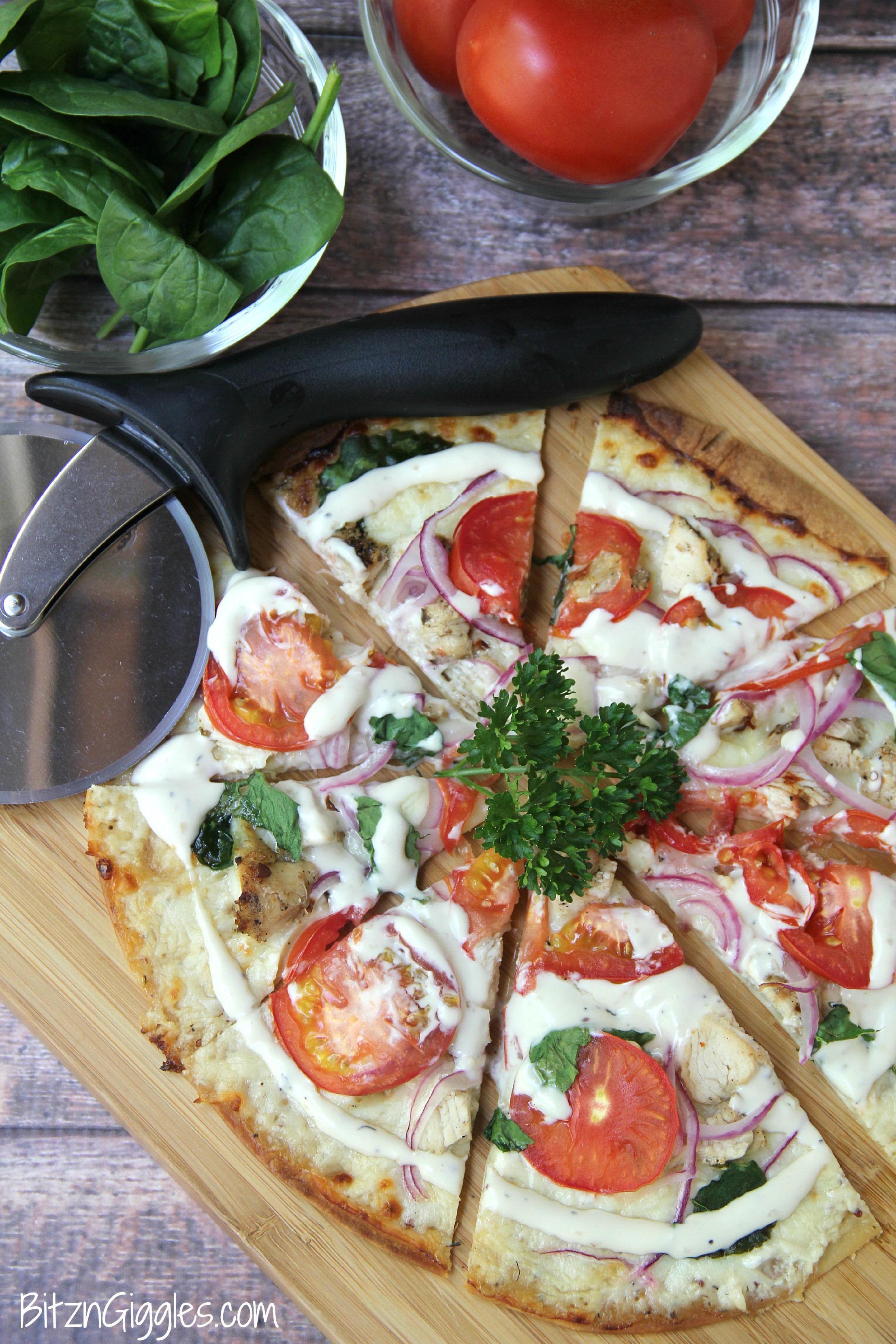 Chicken Ranch Tortilla Pizza - A quick and delicious "skinny" pizza with sprinkles of grilled chicken and fresh vegetables, bursting with mouth-watering garlic and ranch flavors!