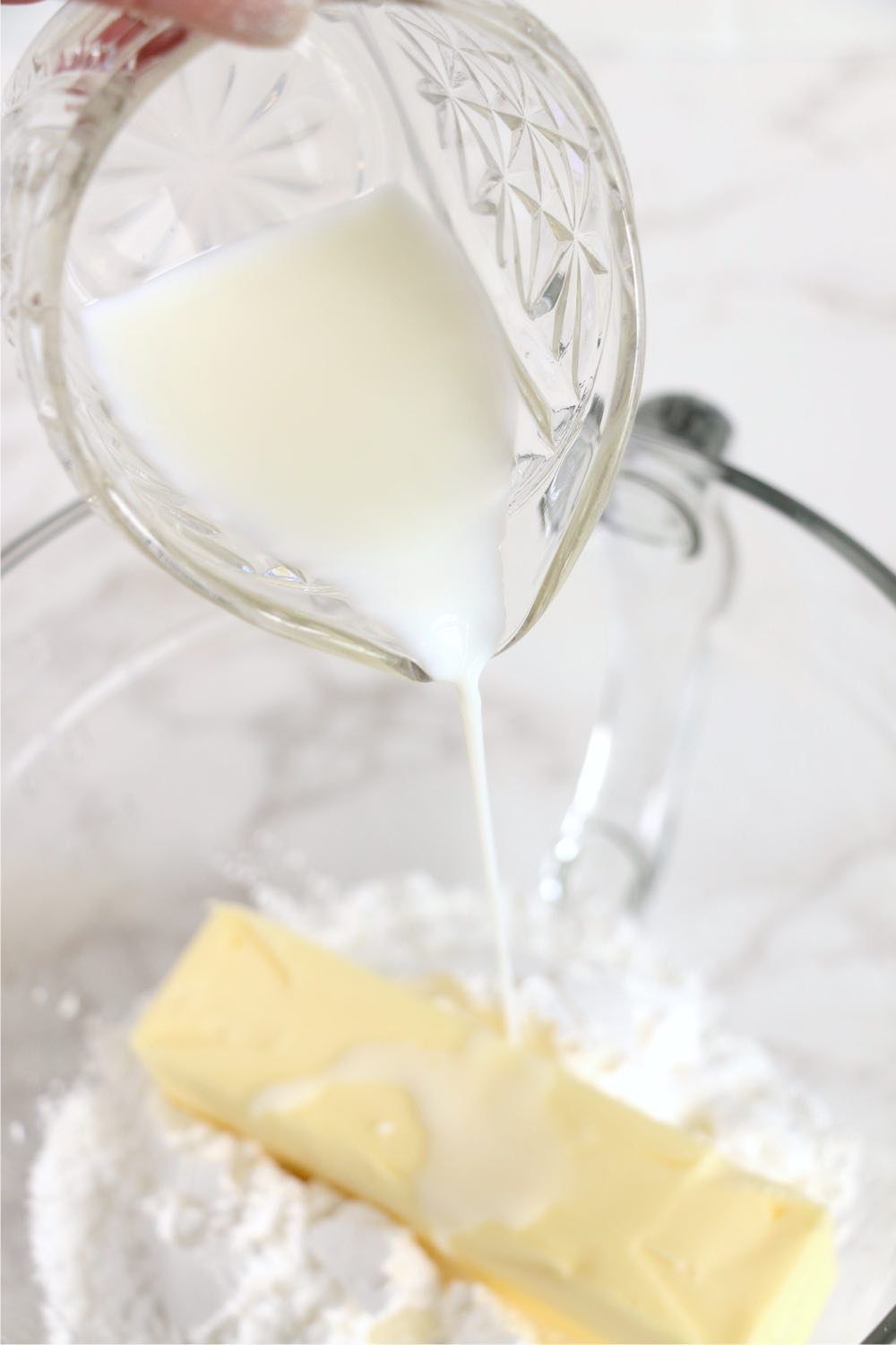 pouring milk into bowl of butter and milk