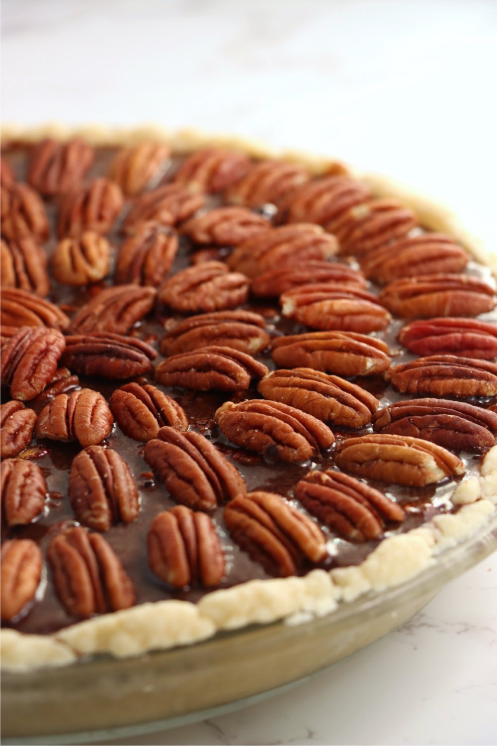 up close shot of decorative top of pecan pie