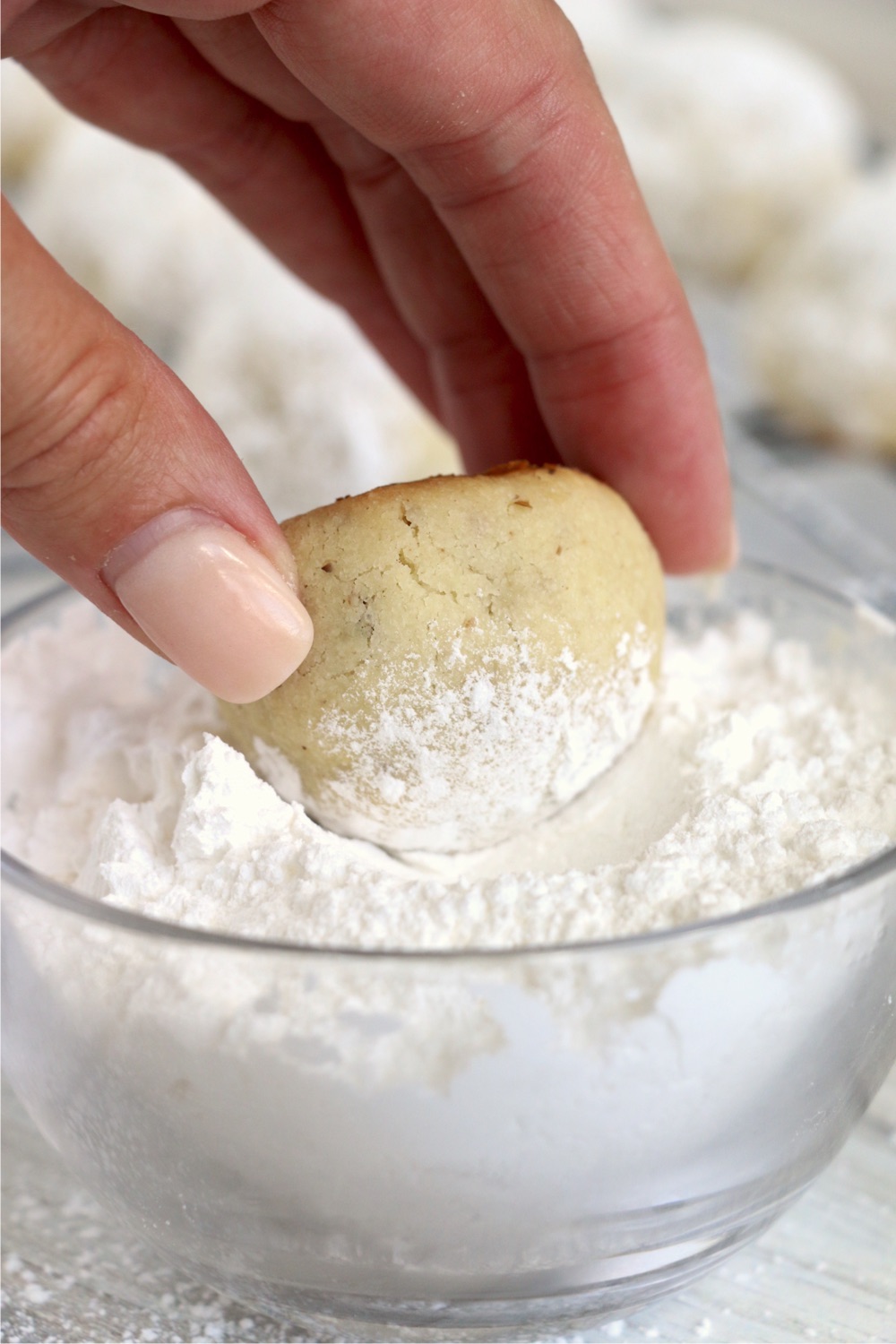 rolling cookie in powdered sugar