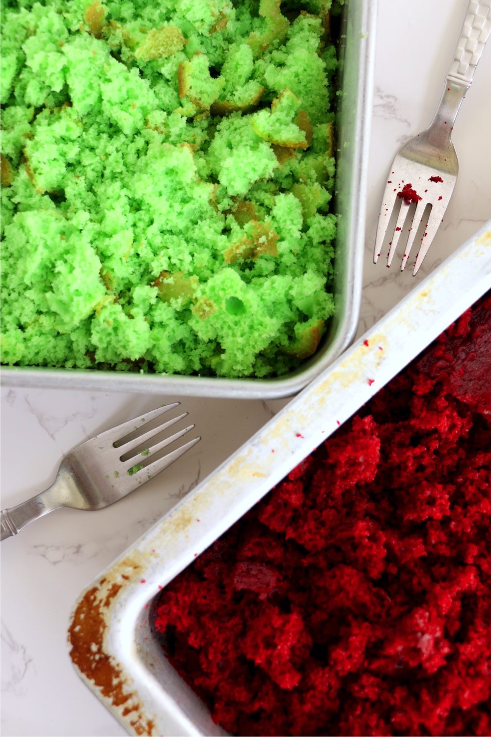 Crumbled red and green cake in 13x9-inch pans.