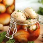small pint mason jar filled with marinated mushrooms