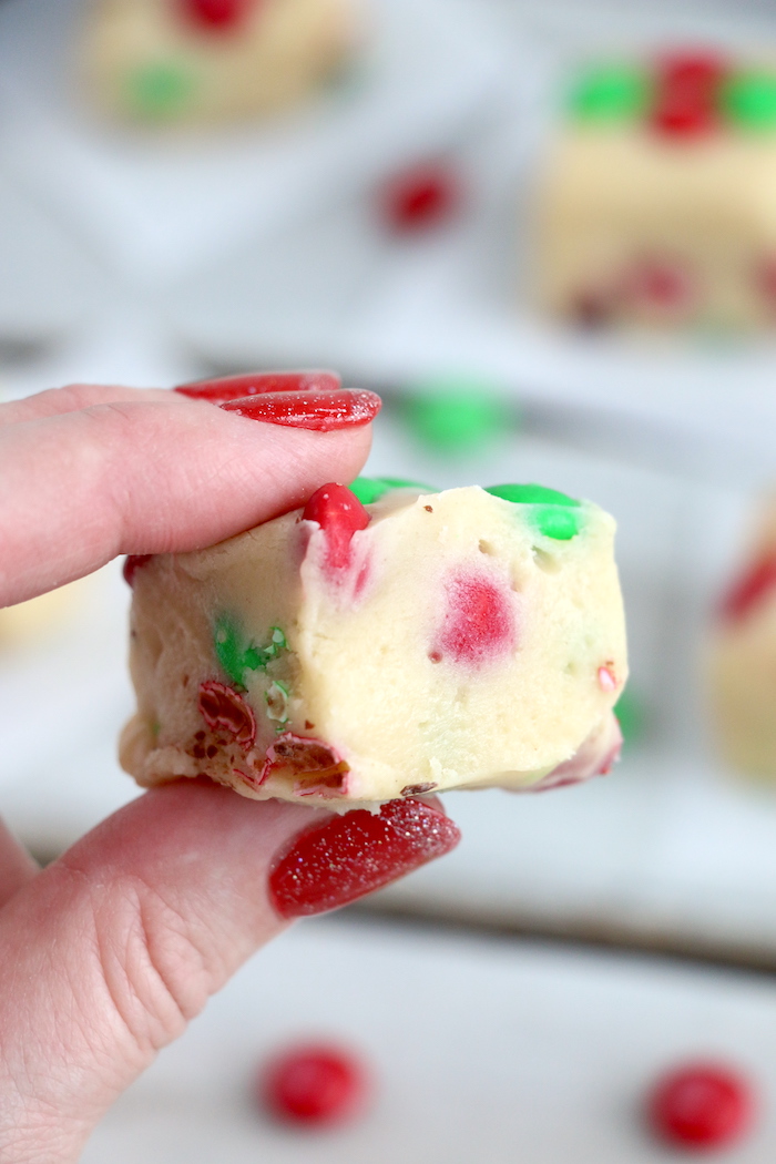 fingers holding M&M cookie dough fudge