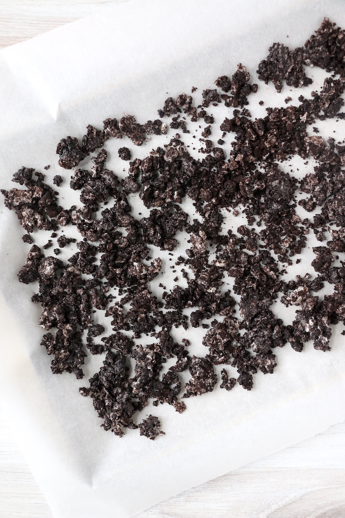 mixing Oreo cookie crumbs with butter in a pan