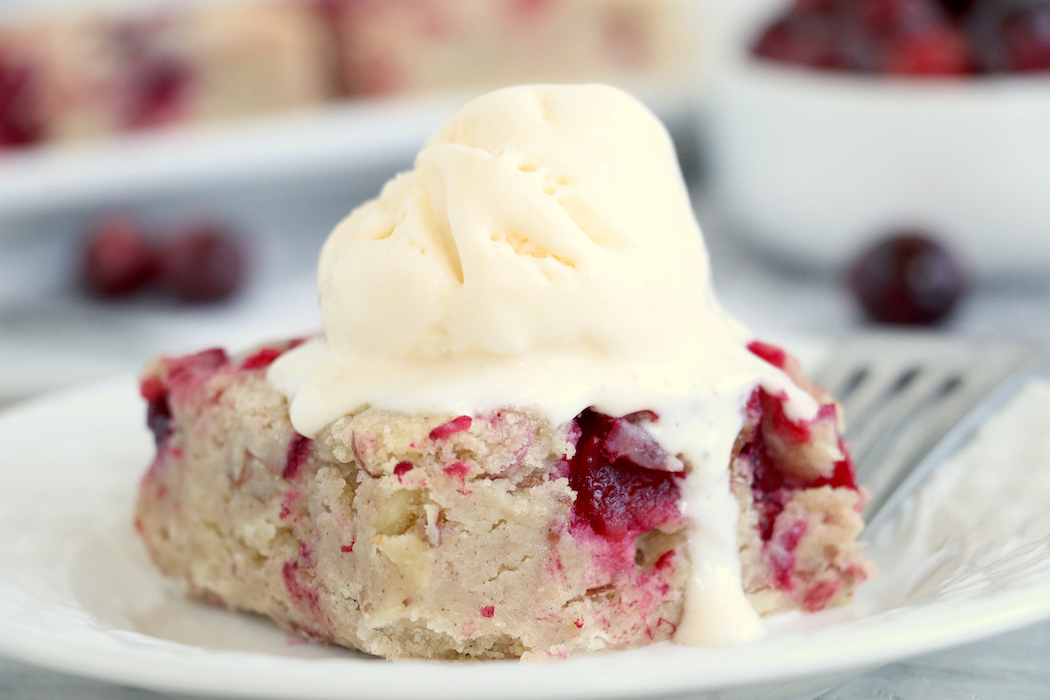 Easy Cranberry Cake - An easy and delicious cake bursting with tart cranberries. Top with vanilla ice cream and enjoy!