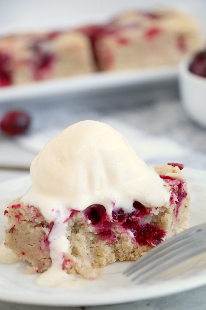 Easy Cranberry Cake - An easy and delicious cake bursting with tart cranberries. Top with vanilla ice cream and enjoy!