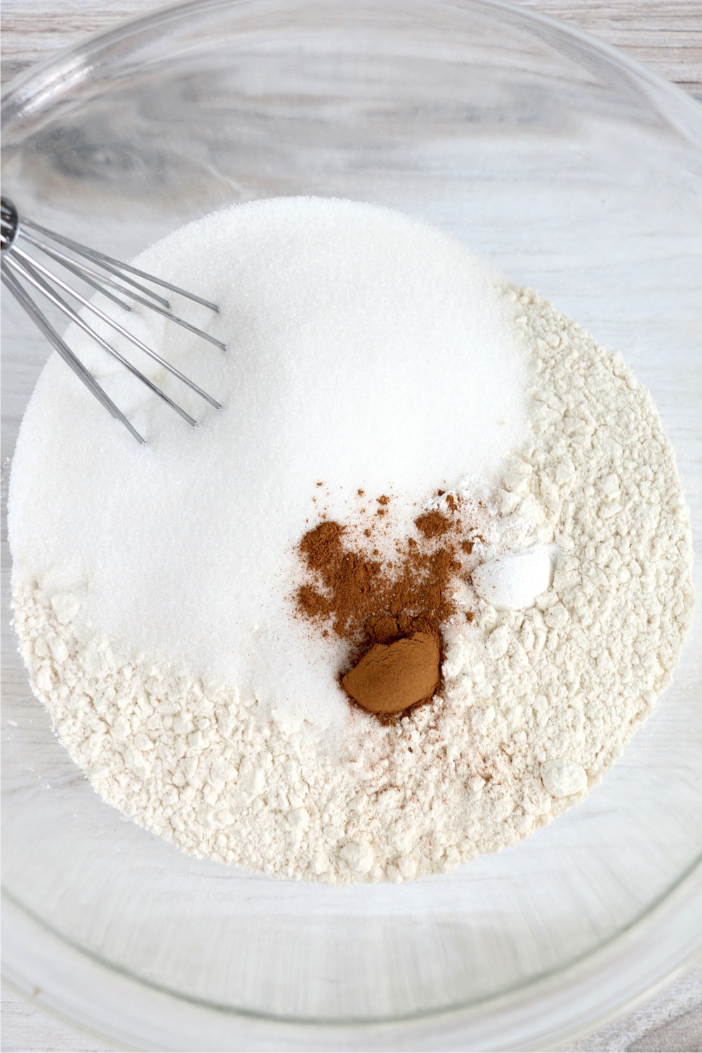 Flour, sugar, baking powder, salt, cinnamon and oatmeal in a large glass mixing bowl