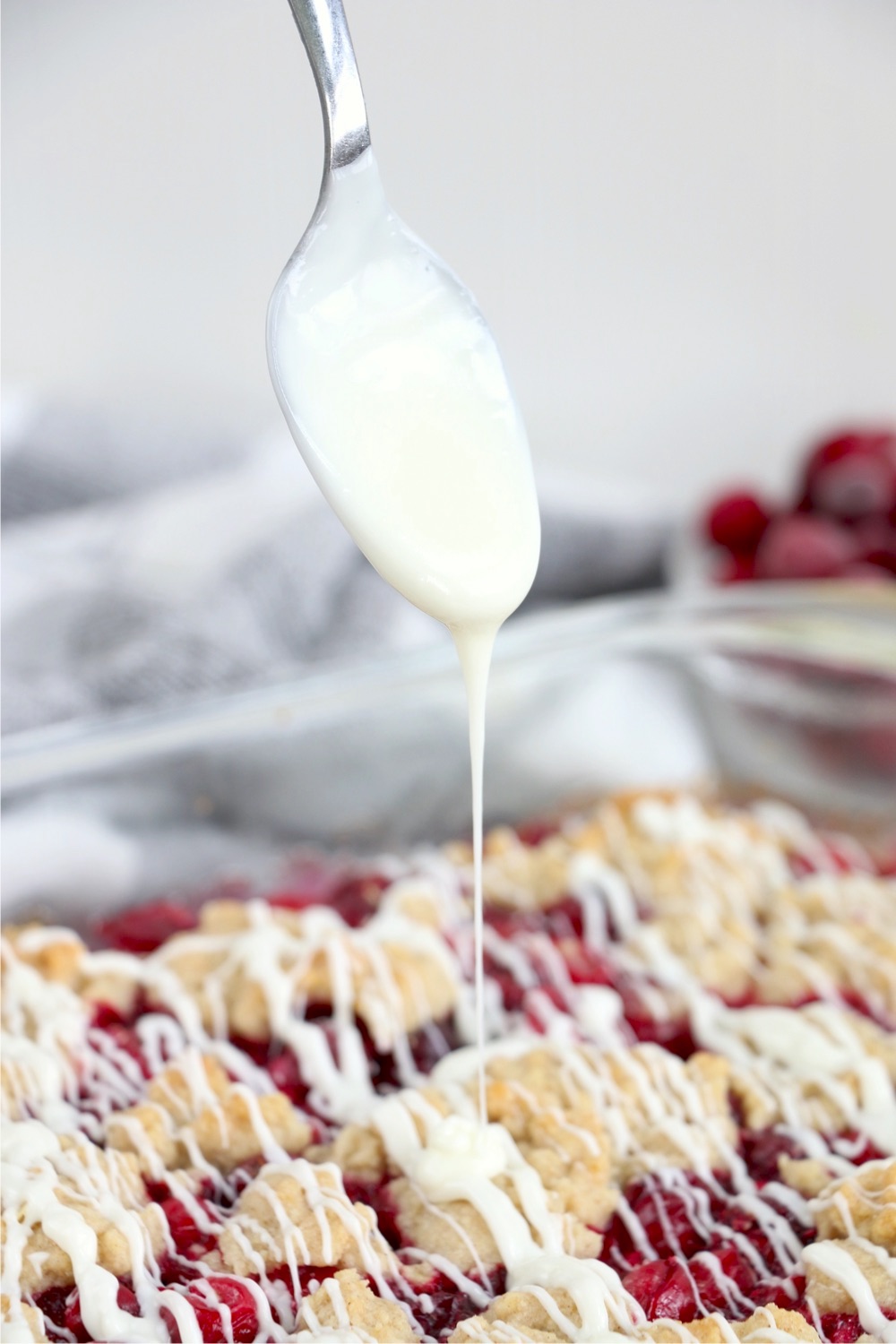 Drizzling icing on cranberry bars