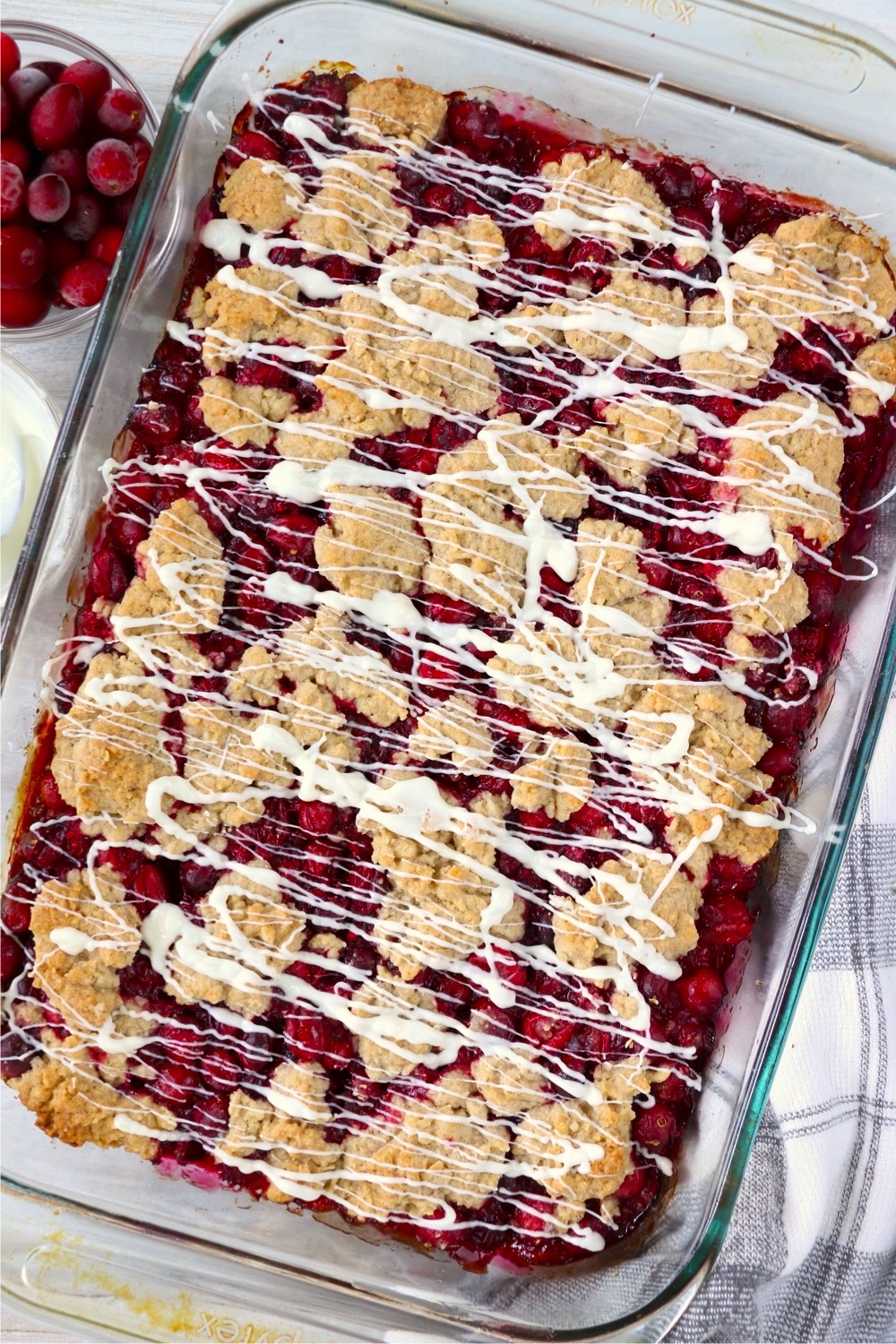 Icing drizzled on cranberry bars in pan