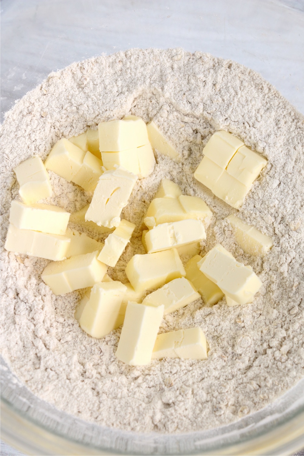 butter pats in a bowl with a crumb mixture