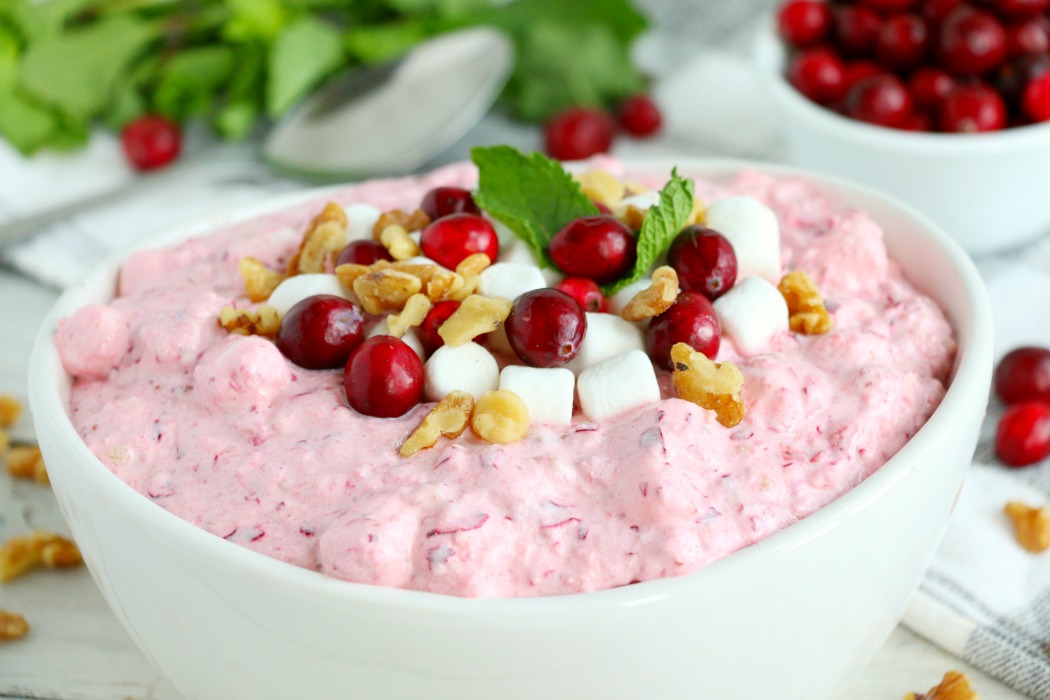 Cranberry Fluff - Tangy, chilled cranberries and sweet crushed pineapple, folded into marshmallow-filled whipped cream makes this side dish a family favorite!