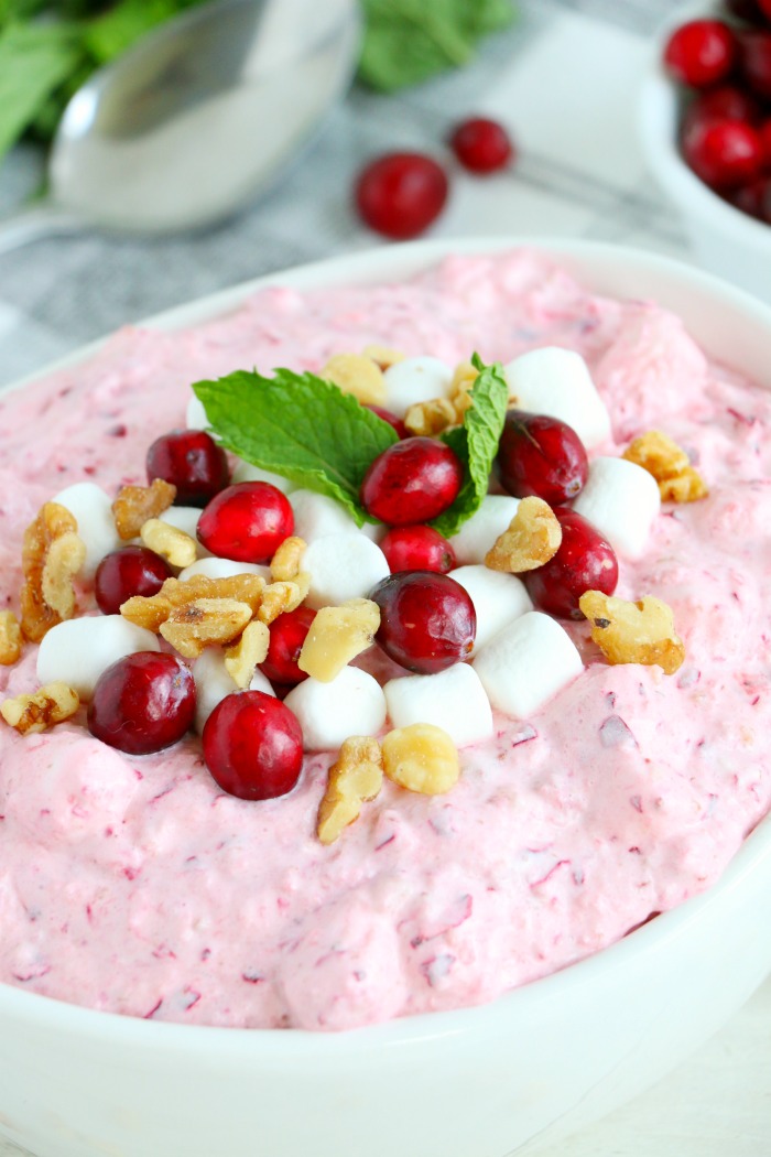 Cranberry Fluff - Tangy, chilled cranberries and sweet crushed pineapple, folded into marshmallow-filled whipped cream makes this side dish a family favorite!