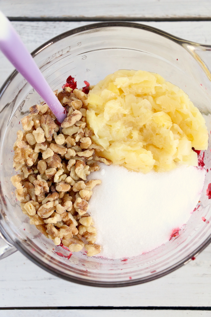 Cranberry Fluff - Tangy, chilled cranberries and sweet crushed pineapple, folded into marshmallow-filled whipped cream makes this side dish a family favorite!