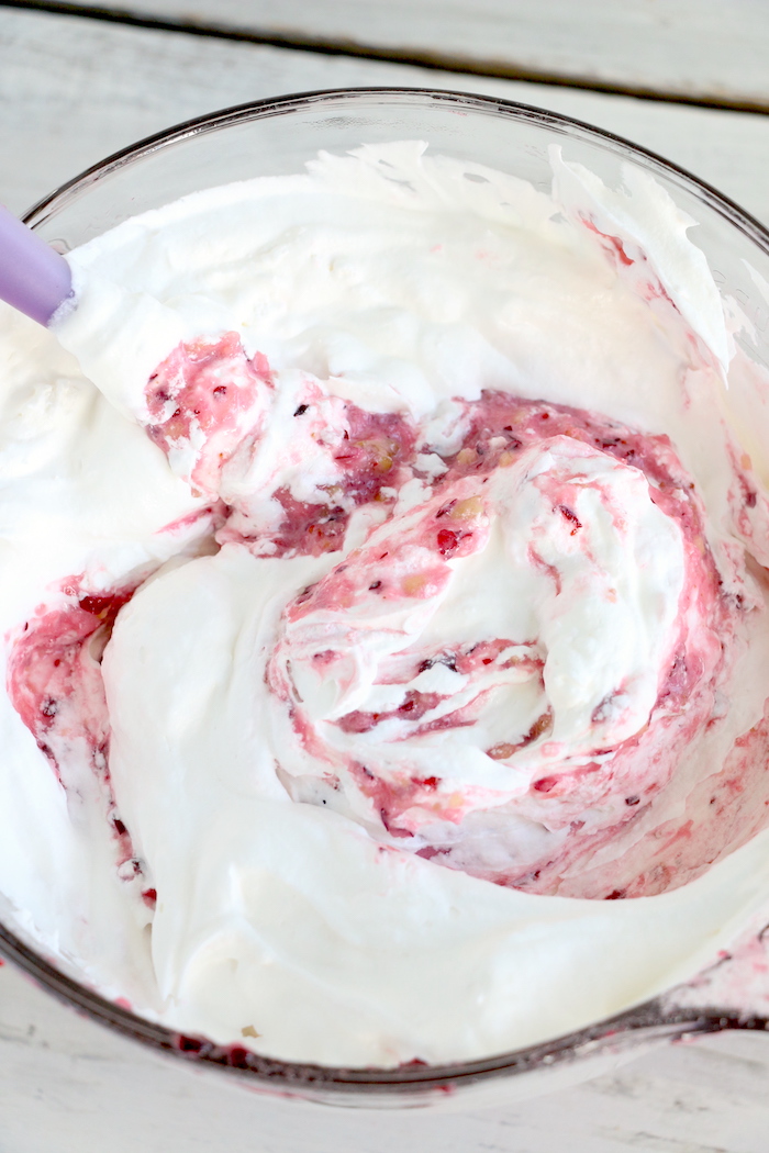 Cranberry Fluff - Tangy, chilled cranberries and sweet crushed pineapple, folded into marshmallow-filled whipped cream makes this side dish a family favorite!