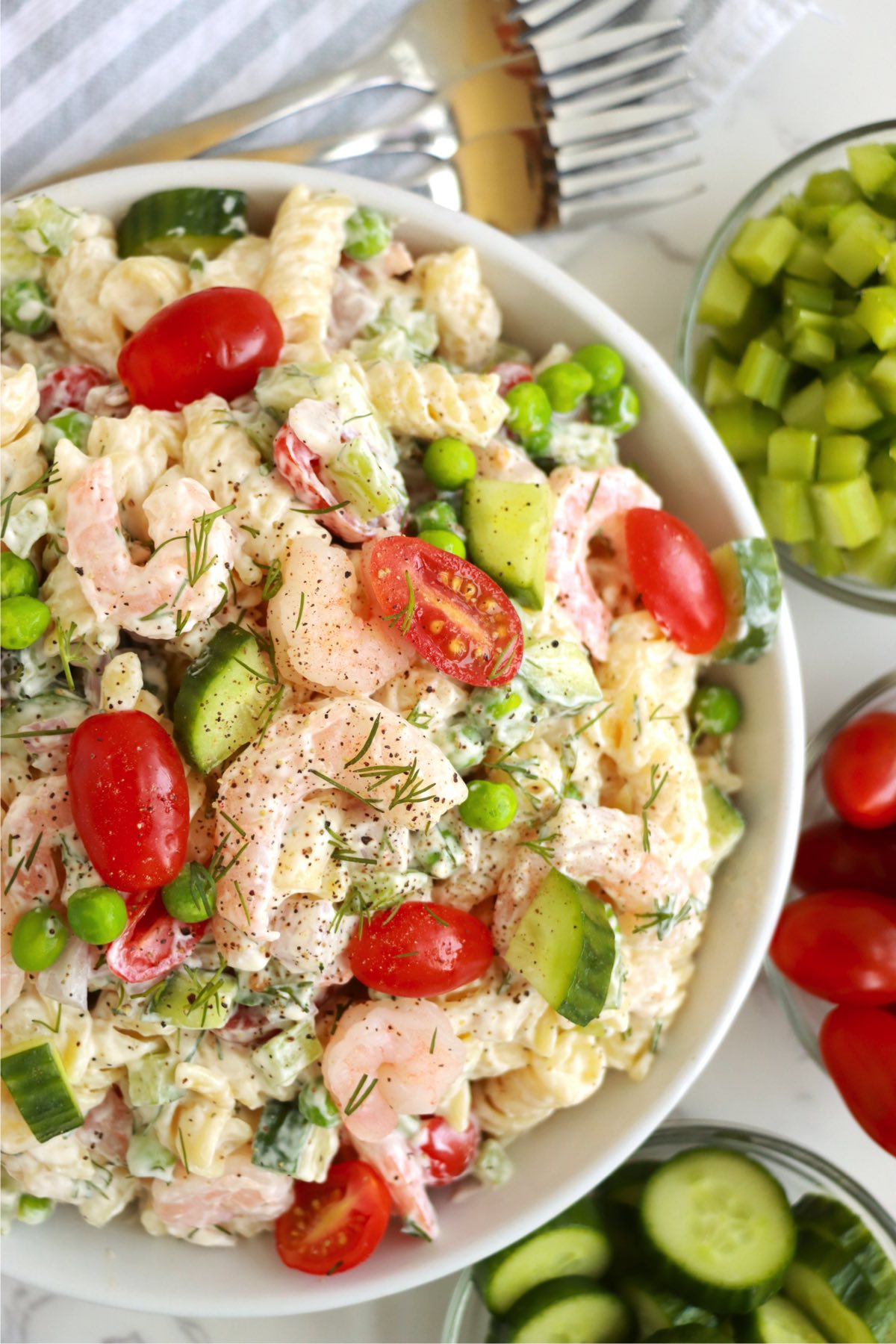looking down at a bowl of shrimp pasta salad