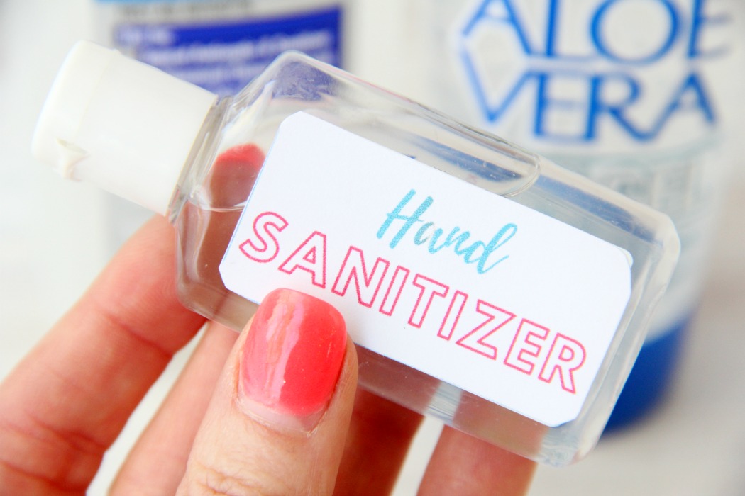 hand holding a bottle of homemade hand sanitizer