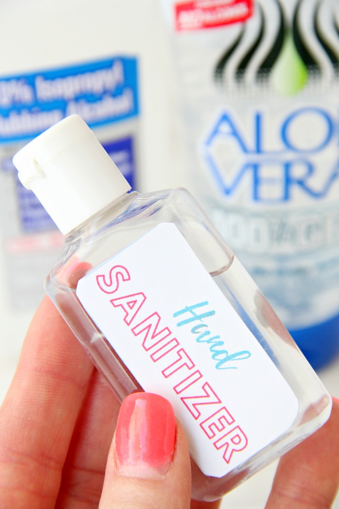 hand holding a bottle of hand sanitizer