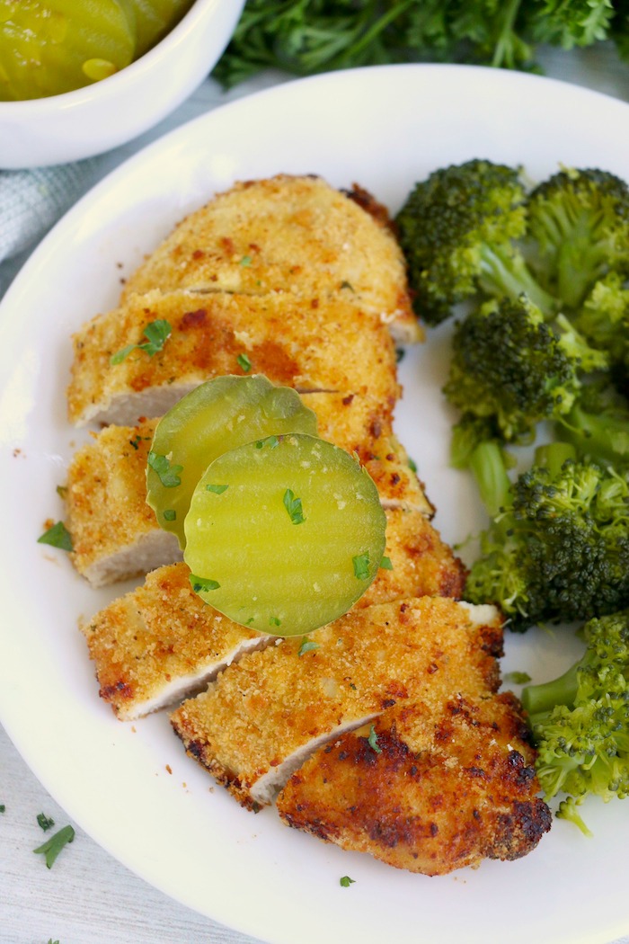 Sliced chicken breast with pickles on top