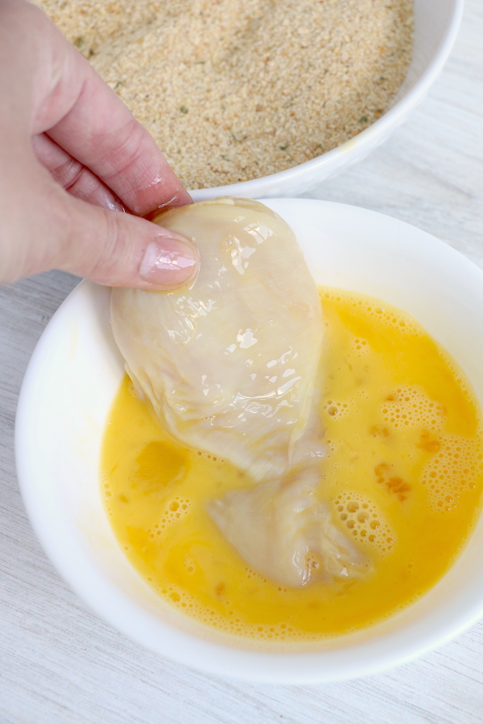 Dredging chicken in beaten eggs