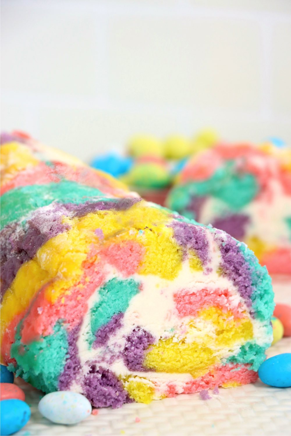 Pastel colored cake roll filled with buttercream frosting