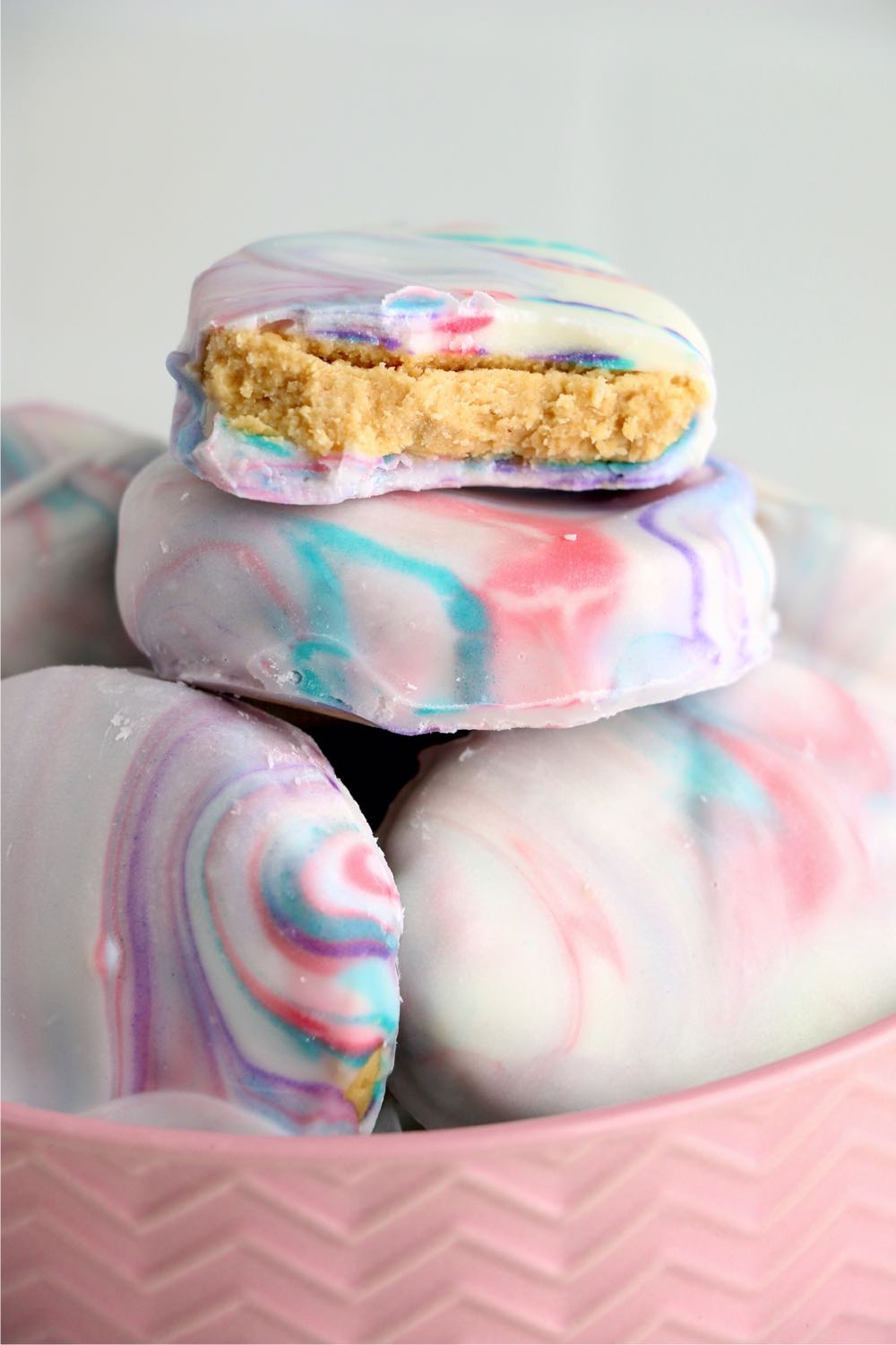 a stack of peanut butter eggs with a bite out of one