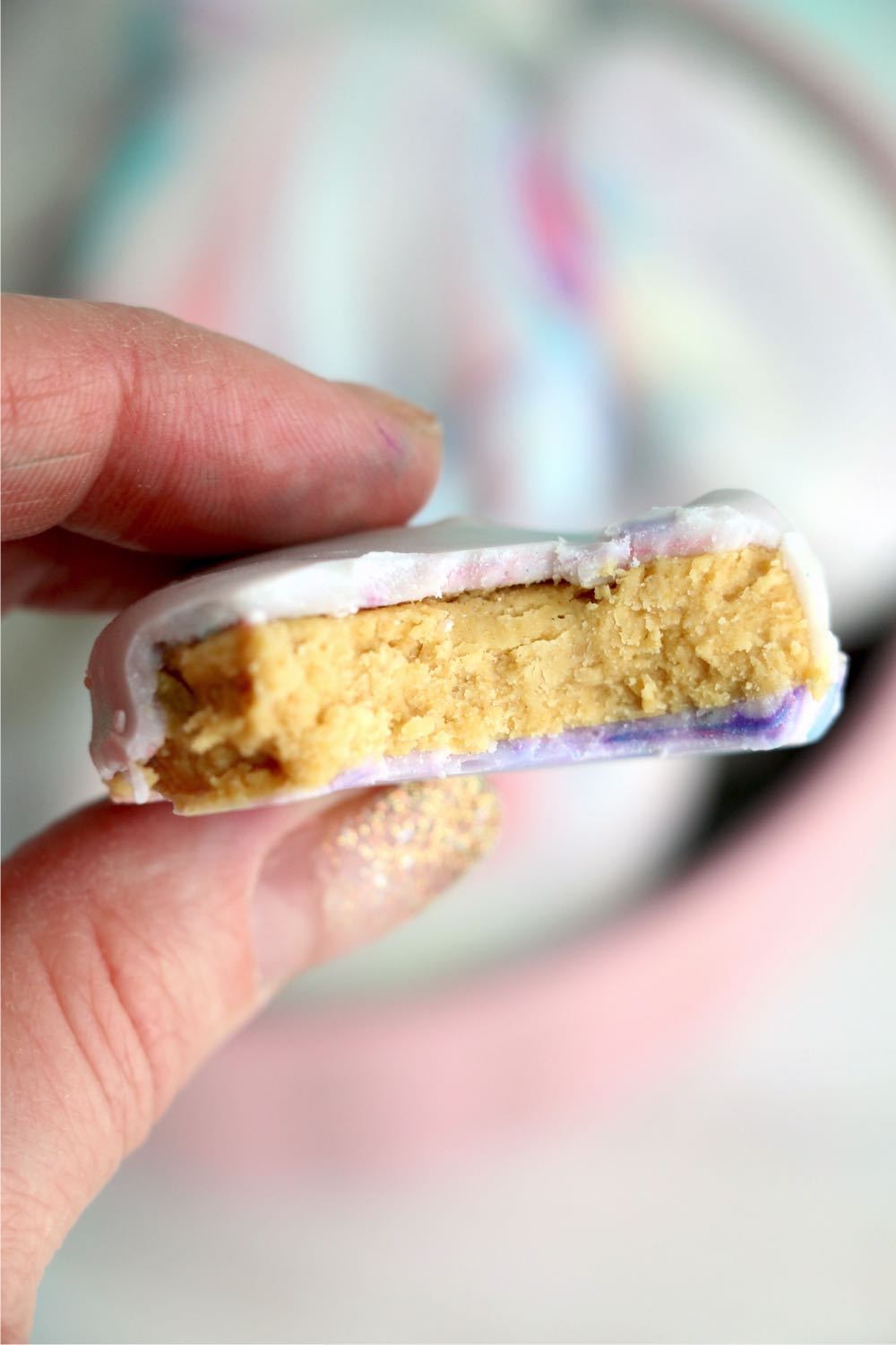 holding a peanut butter egg with a bite out of it