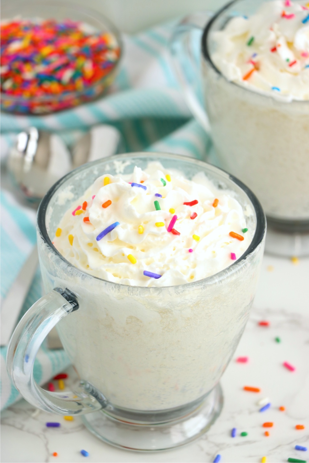 glass mug with vanilla cake and whipped topping