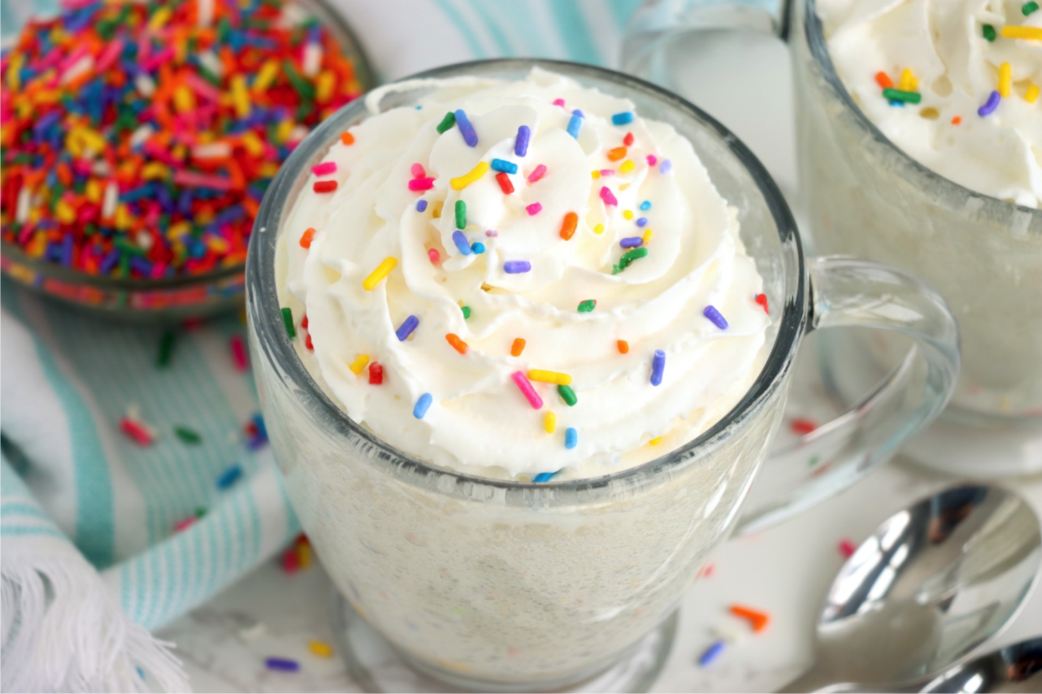 mug cake with bowl of sprinkles in the background