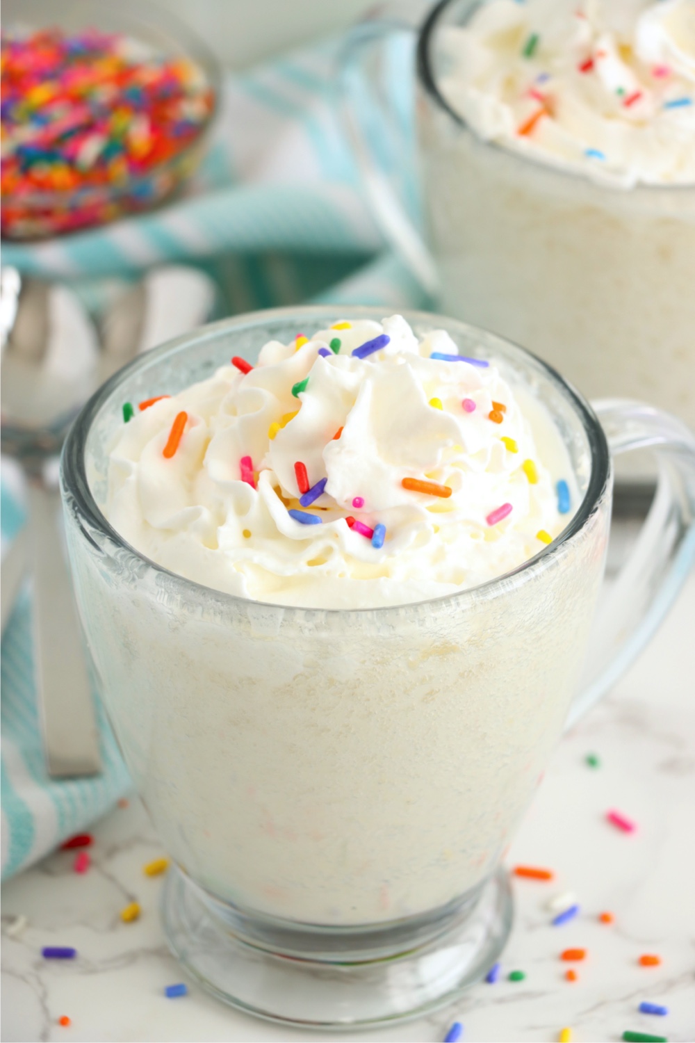 clear mug with cake and confetti sprinkles