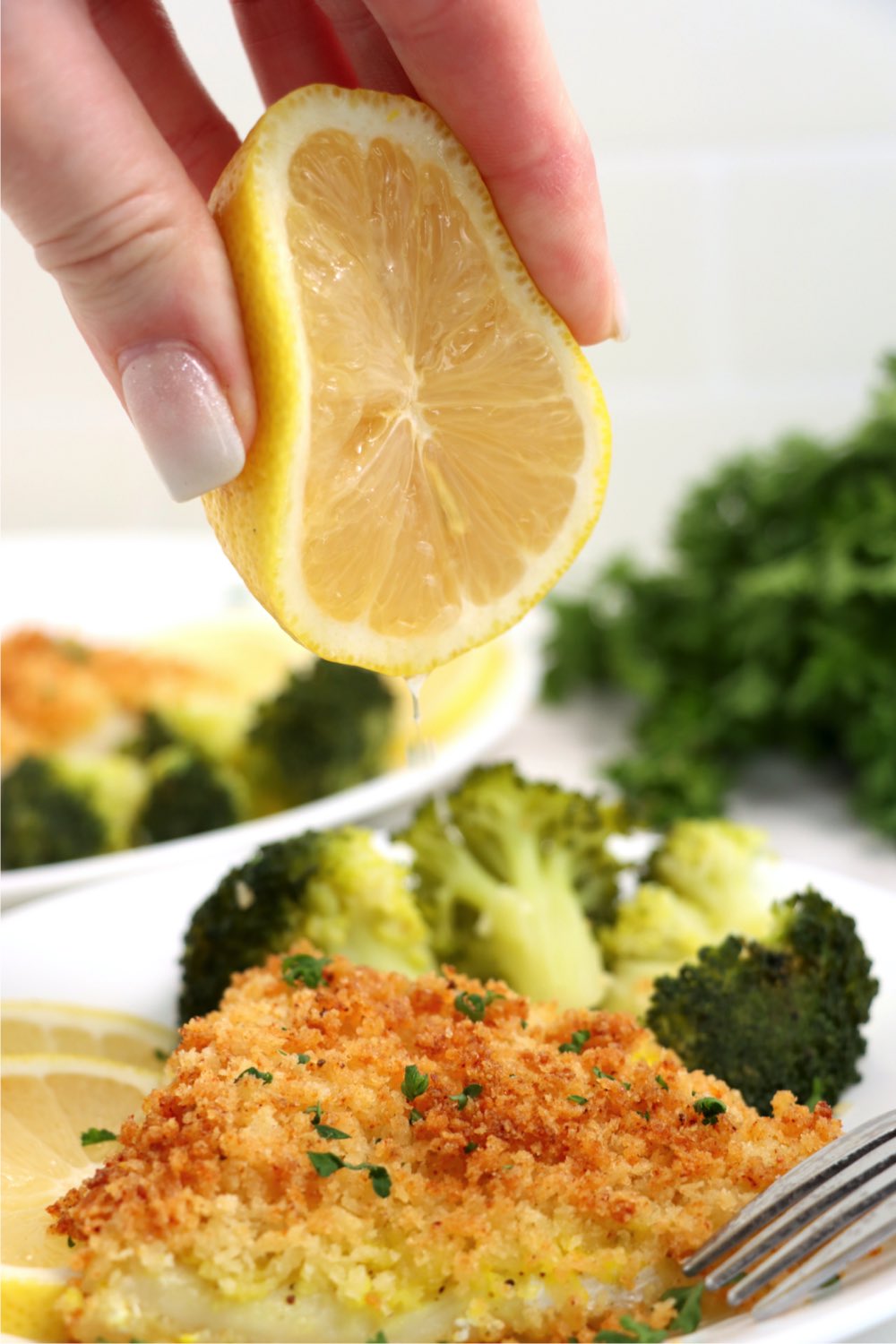 squeezing lemon onto air fryer cod