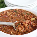 spoon in dish of baked beans