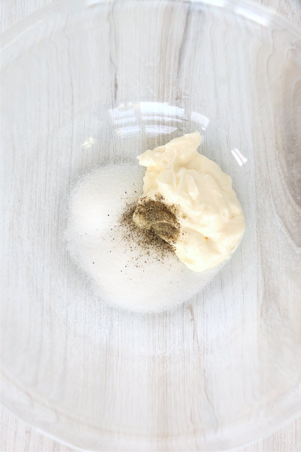 coleslaw ingredients in glass mixing bowl