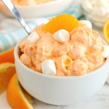 white bowl filled with orange fluff with a spoon